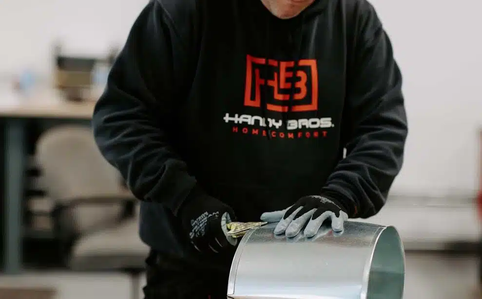 A Handy Bros. technician organizing tools neatly, ensuring efficiency and readiness for HVAC service and repairs.