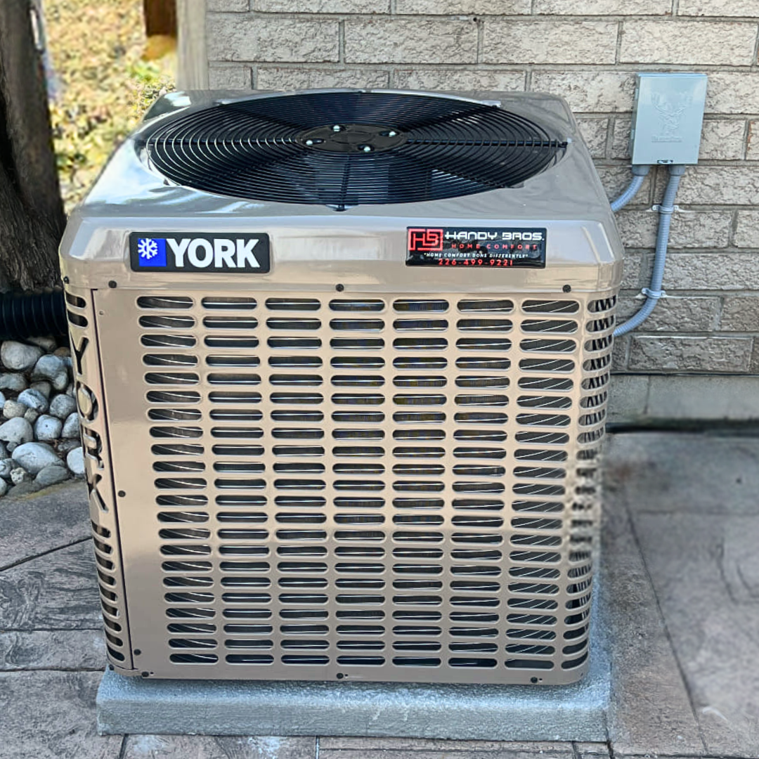 Handy Bros. air conditioning unit installed outside of a customers home, featuring the HB logo.