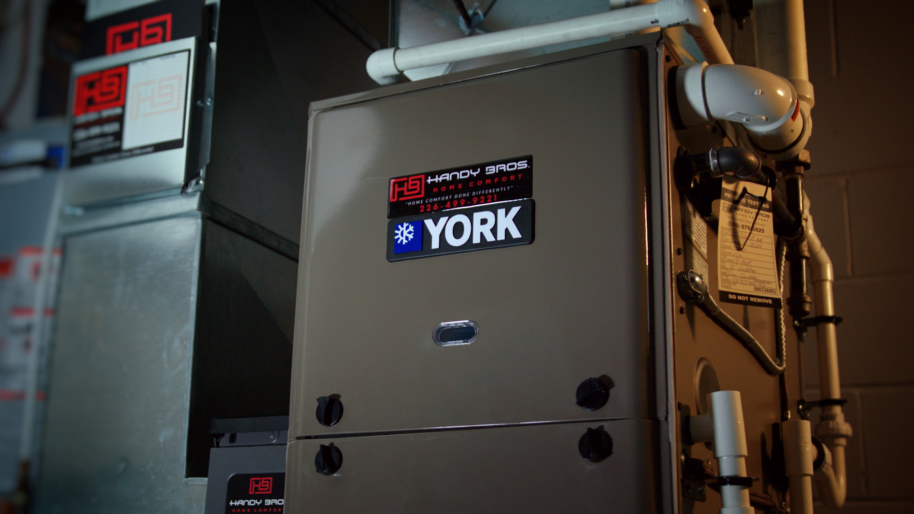 A Handy Bros. technician installing a furnace, ensuring proper setup for efficient and reliable home heating.