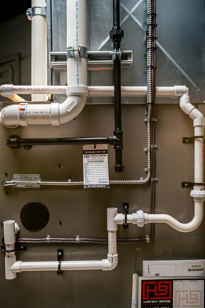 Side view of a fully installed furnace, displaying connected piping, vents, and professional installation details.