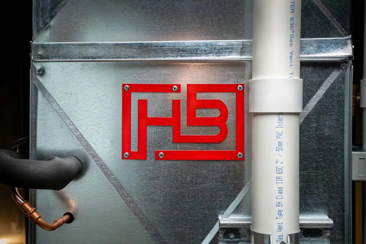 A close-up of the Handy Bros. logo on a furnace, showcasing the brand’s commitment to quality heating solutions.