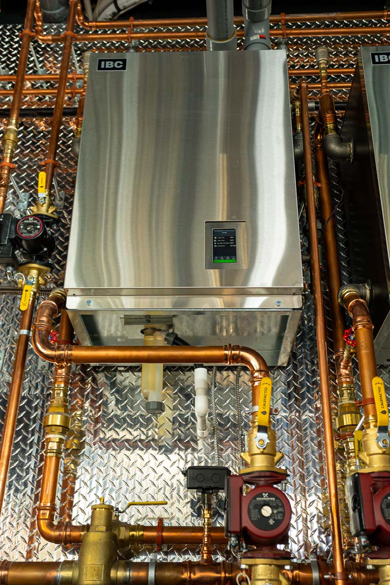 A Handy Bros. technician servicing a boiler, ensuring optimal performance and energy efficiency.