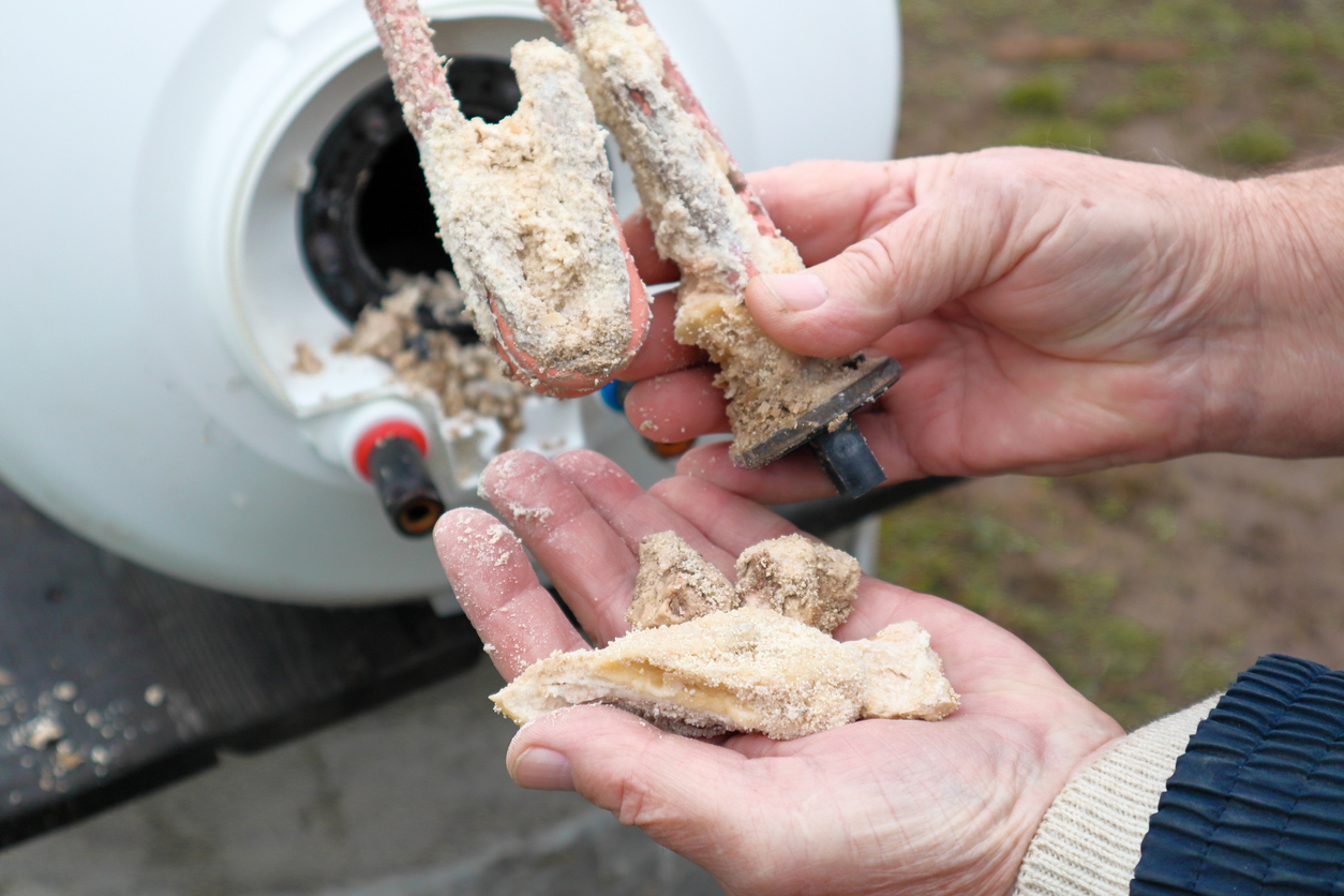 Lime deposits on stainless steel heating element and anode. Replacement of heating element affected by scale and limescale