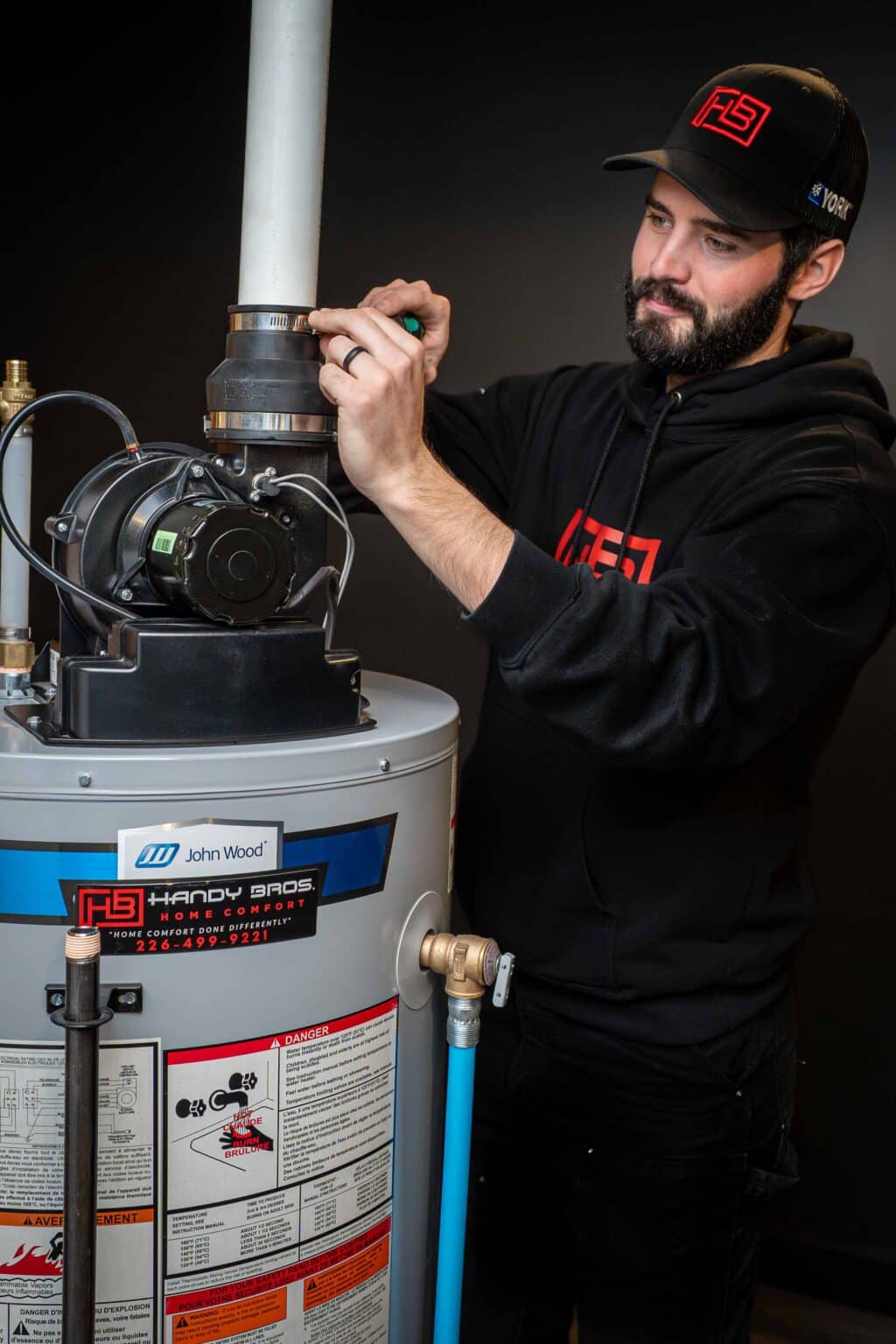 A Handy Bros. technician repairing a water heater to restore reliable hot water supply for the home.