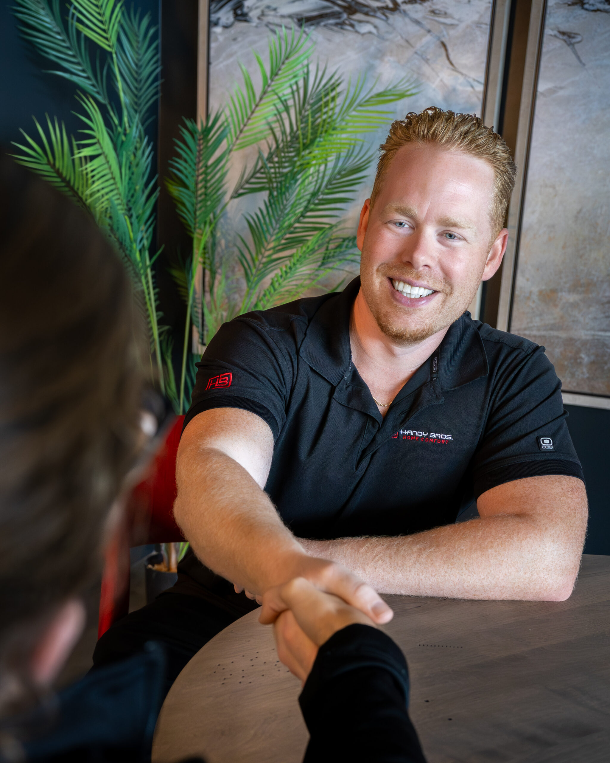 a man shaking hands with a customer