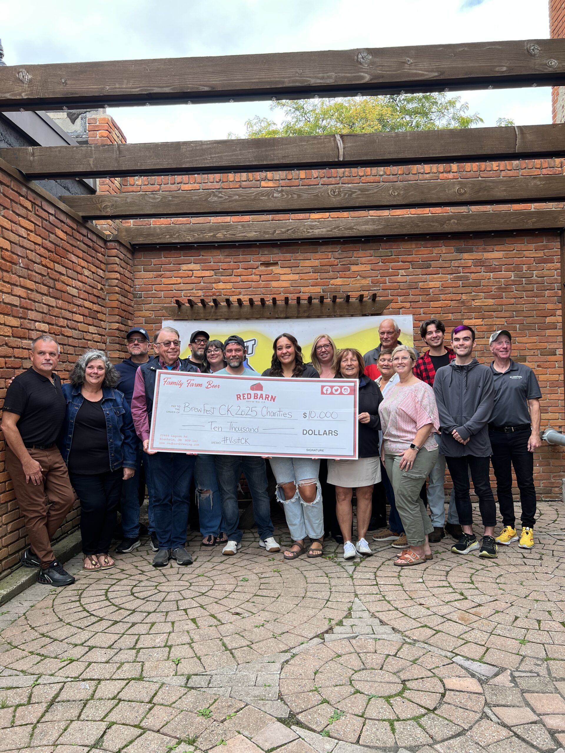a group of people holding a large check