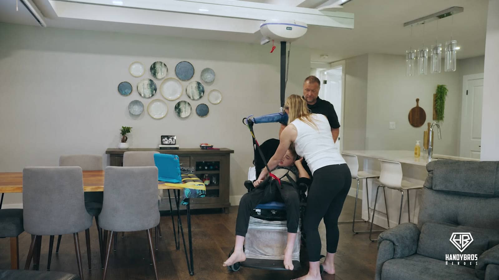 Amanda uses the new ceiling-track lift to transfer Bentley safely in the family’s living space.