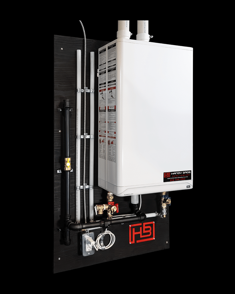 Wall-mounted white tankless water heater on a Handy Bros service backboard with visible piping.